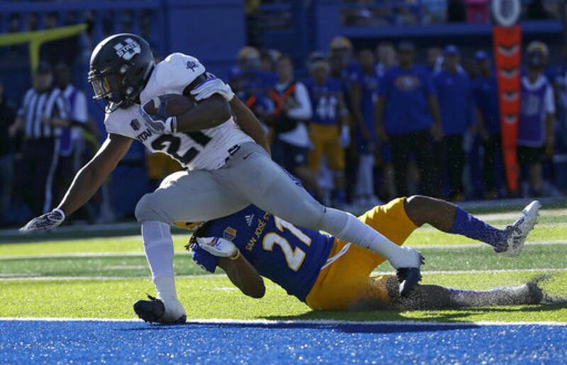Utah State running back LaJuan Hunt, left, scores a touchdown against San Jose State cornerback Andre Chachere during the first half of an NCAA college football game in San Jose, Calif., Saturday, Sept. 23, 2017. (AP Photo/Jeff Chiu)