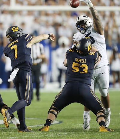 Brigham Young Cougars defensive lineman Khyiris Tonga (95) blocks a pass by California Golden Bears quarterback Chase Garbers (7) in Provo on Saturday, Sept. 8, 2018.
