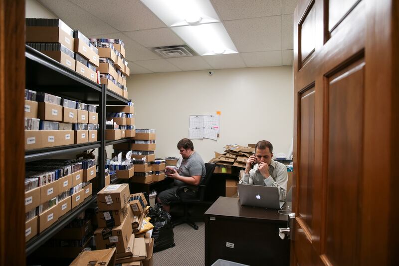 Neal Harmon, cofounder and CEO of VidAngel, right, places a phone call while Matthew Holland, left, works in the receiving room at VidAngel's office in Provo on Wednesday, July 20, 2016.