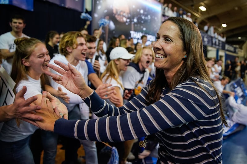 BYU women’s volleyball head coach Heather Olmstead celebrates after winning against Utah in an NCAA volleyball game.