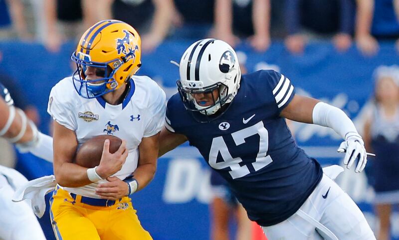 BYU linebacker Jackson Kaufusi (47) tackles McNeese State quarterback Cody Orgeron, left, in the second half during an NCAA college football game Saturday, Sept. 22, 2018, in Provo, Utah. (AP Photo/Rick Bowmer)