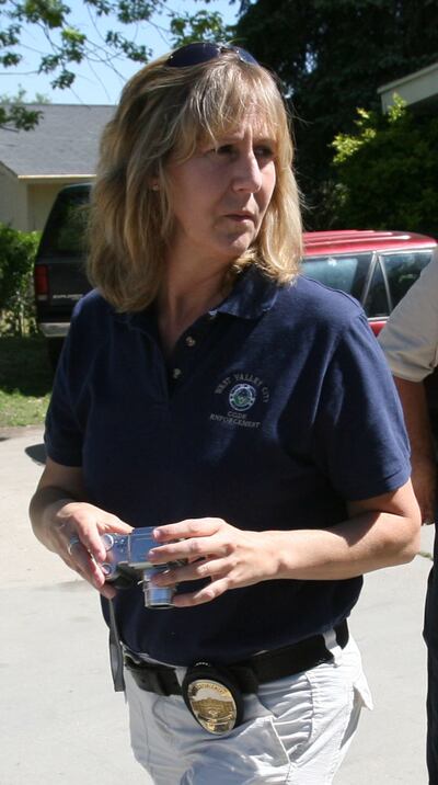 West Valley Code Enforcement Officer Jill Robinson checks a home for violations on June 20, 2008.