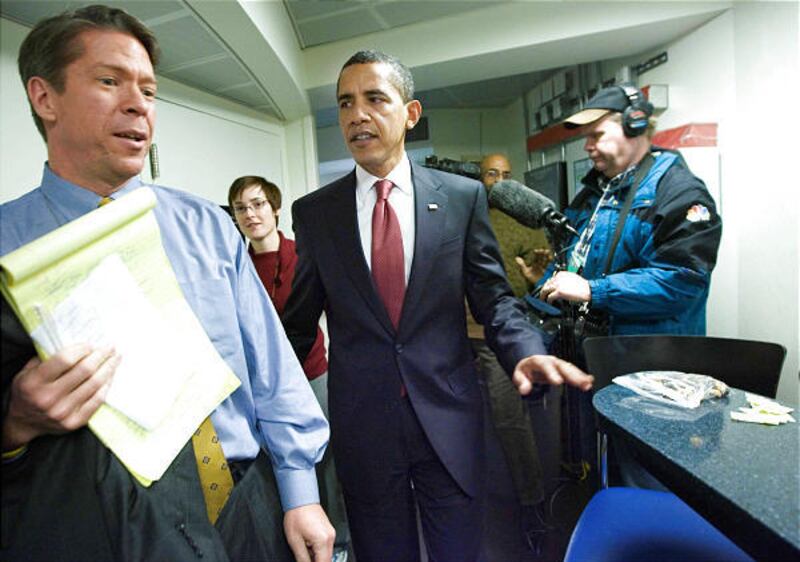 In this Jan. 22 file photo, President Barack Obama, center, stands near Fox News' Major Garrett, left, in the kitchen of the Brady press briefing room at the White House in Washington.