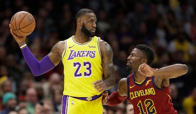Los Angeles Lakers’ LeBron James, left, looks to pass the ball as Cleveland Cavaliers’ David Nwaba defends.