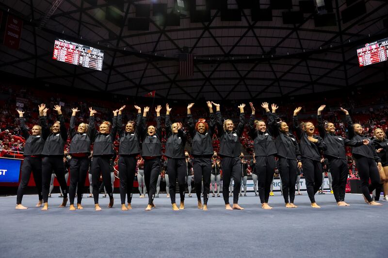 The Red Rocks, gymnasts at the University of Utah, thank the fans after defeating Minnesota.