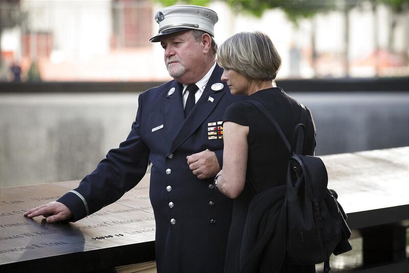 Retired FDNY Lt. Jerry Collins and his wife Suzanne Collins pause at the 9/11 Memorial in New York on Wednesday. , May 30, 2012, in New York. Recovery workers and first responders were invited to the memorial to be honored on the
