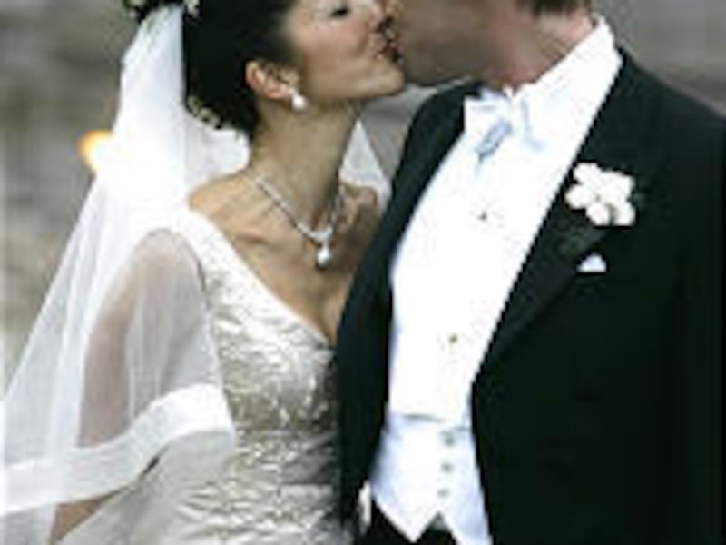 Hong Kong-born Princess Alexandra of Denmark kisses new husband Martin Joergensen on Saturday.