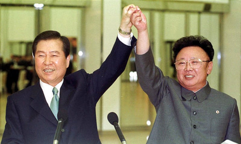 In this June 14, 2000 file photo, South Korean President Kim Dae-jung, eft, and North Korean leader Kim Jong Il raise their arms together before signing a joint declaration at the end of the second day of a three-day summit in Pyongyang, North Korea.