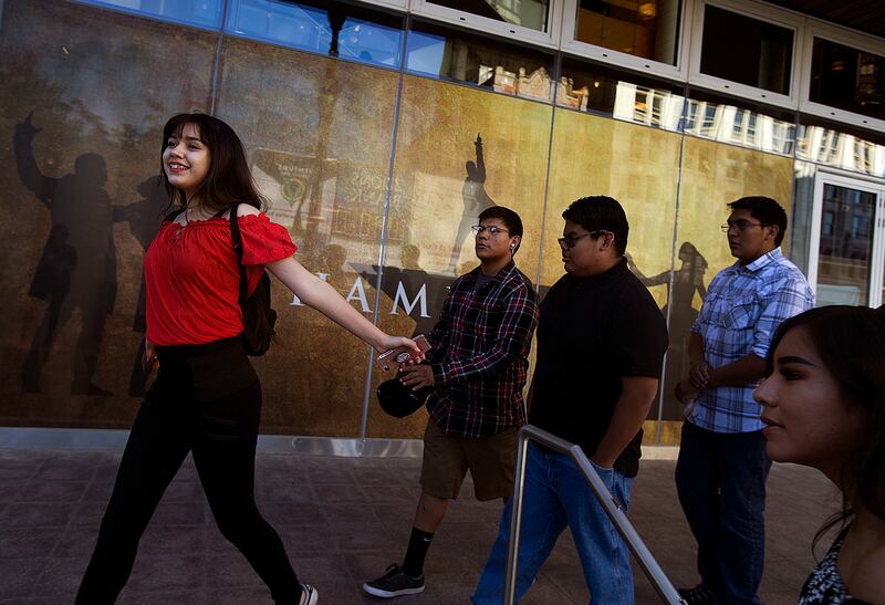 Dachuneeh Martin, left, a ninth-grader from Whitehorse High School in Montezuma Creek, runs to the door of the theater in anticipation of seeing “Hamilton” at the Eccles Theater in Salt Lake City on Friday, May 4, 2018. More than 2,000 high school student