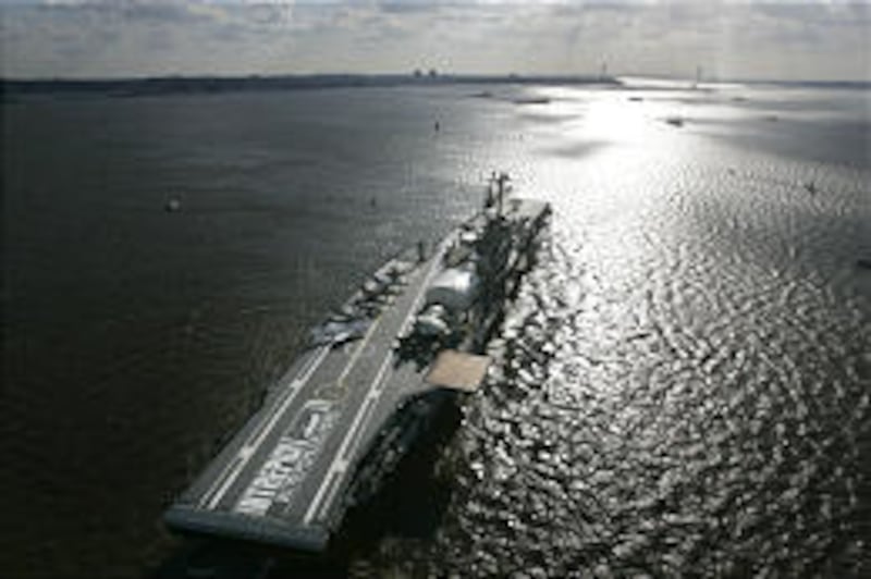 The 27,000-ton USS Intrepid aircraft carrier is moved at 3 mph down the Hudson River on Tuesday. The ship has no engine.