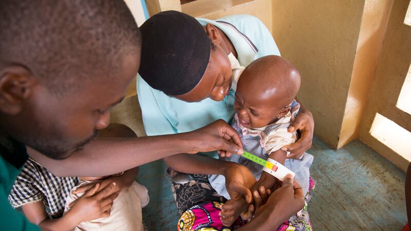 A physician measures a young child's mid-upper-arm circumference to gauge the nutrition assistance needed at the Soeurs De Saint Joseph De Arbes Health Center near Kananga, Democratic Republic of Congo on Aug. 22, 2017. The latest World Food Programme/Foo