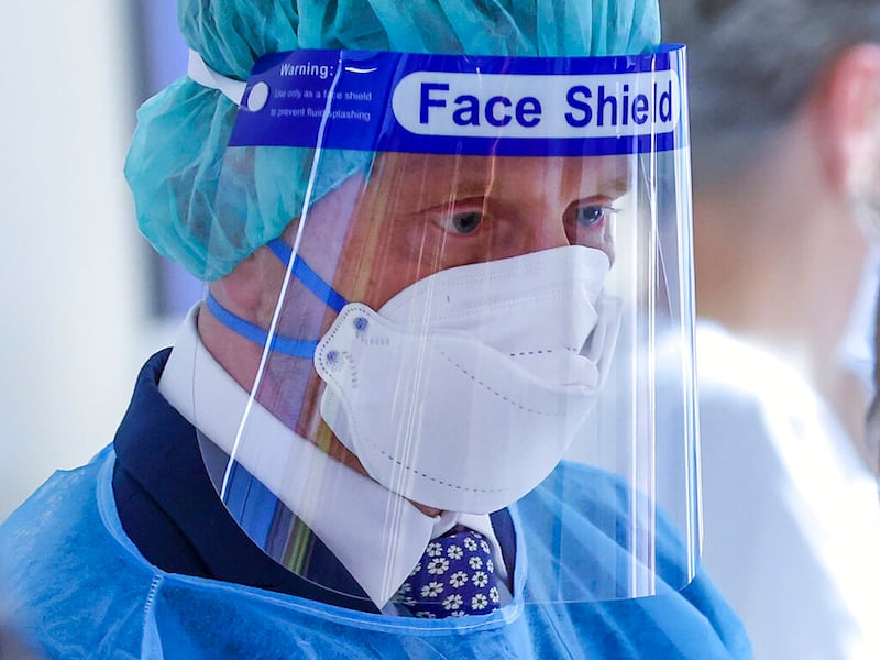 Michael Kretschmer, prime minister of Saxony in Germany, wears a mask and face shield at a COVID-19 ward.