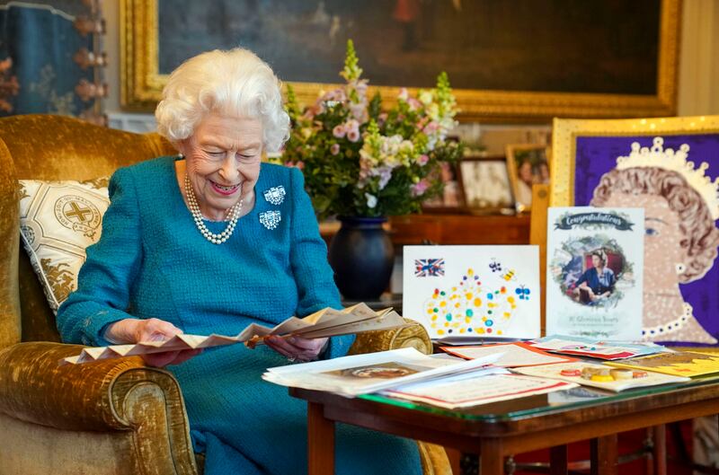 Britain’s Queen Elizabeth II looks at a display of memorabilia from her Golden and Platinum Jubilees in the Oak Room at Windsor Castle, Windsor, England, on Friday Feb. 4, 2022. Queen