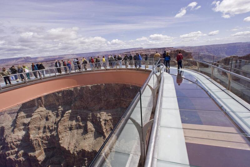 FILE - In this March 28, 2007 file photo, tourists walk on the glass-bottomed Skywalk that extends 70 feet over the edge of Grand Canyon West's Eagle Point, in Arizona. A Las Vegas developer must keep fighting in tribal court as he tries to retain his con