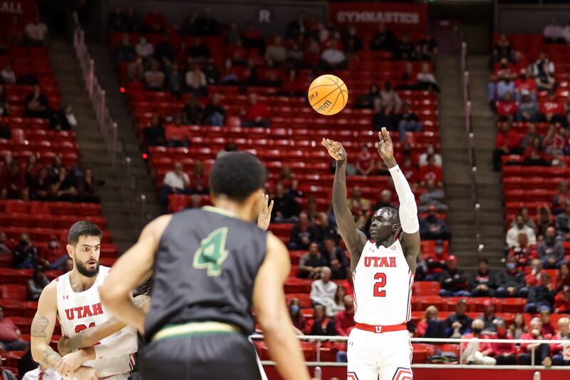 Utah Utes guard Both Gach, wearing white, shoots