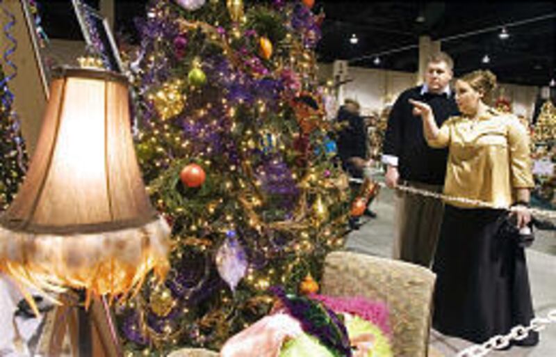 Josh Judd and Chelsy Barton check out one of the more than 700 trees at this year's Festival of Trees at South Towne Center.