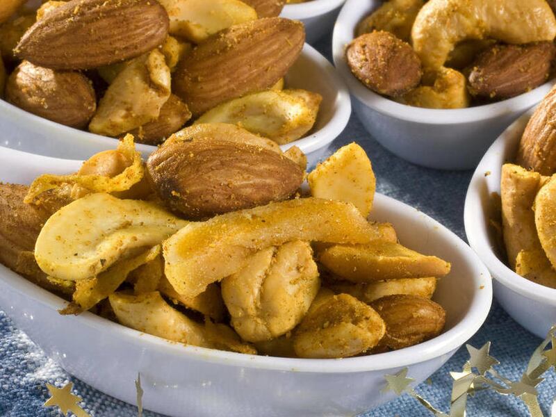 This Nov. 21, 2010, photo shows curried tropical nut mix in Concord, N.H. Nuts are easy to portion control, even at a party. Instead of putting out a big bowl, offer shot glasses and small bowls filled with nuts.