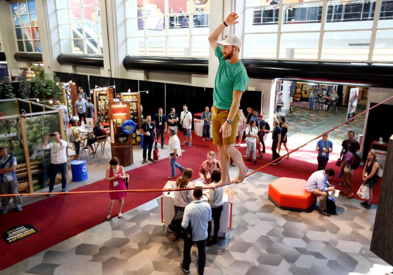 FILE - Ryan Robinson performs stunts on a slackline at the Mountain Hardware booth during the Outdoor Retailer Summer Market at the Salt Palace Convention Center in Salt Lake City on Wednesday, Aug. 3, 2016.