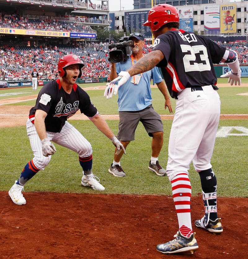FILE - U.S. Team Peter Alonso, of the New York Mets celebrates his two-run homer against the World Team in the seventh inning of the All-Star Futures baseball game, Sunday, July 15, 2018, at Nationals Park, in Washington. The the 89th MLB baseball All-Sta