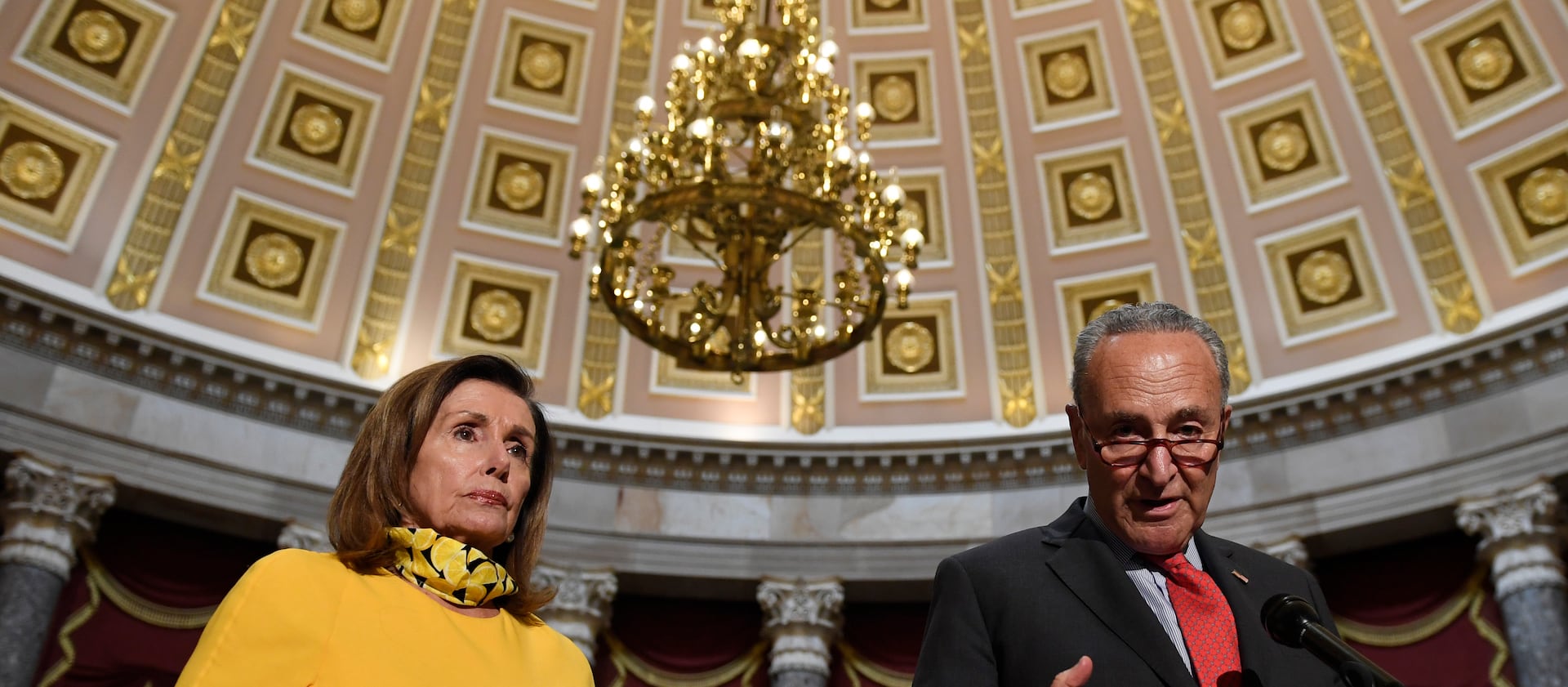 House Speaker Nancy Pelosi, of Calif., left, listens to Senate Minority Leader Sen. Chuck Schumer, of N.Y., on Capitol Hill.