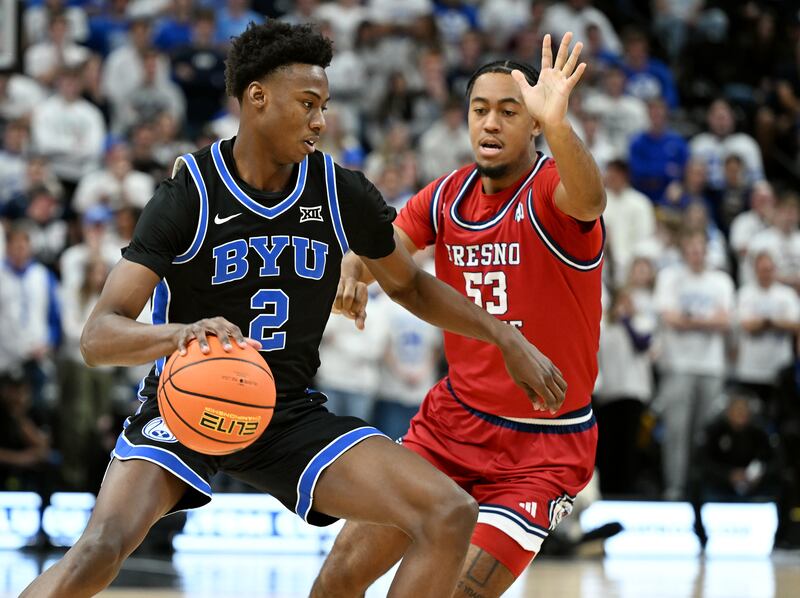 BYU guard Jaxson Robinson works against Fresno State’s Xavier DuSell at the Delta Center in Salt Lake City on Dec. 1, 2023.