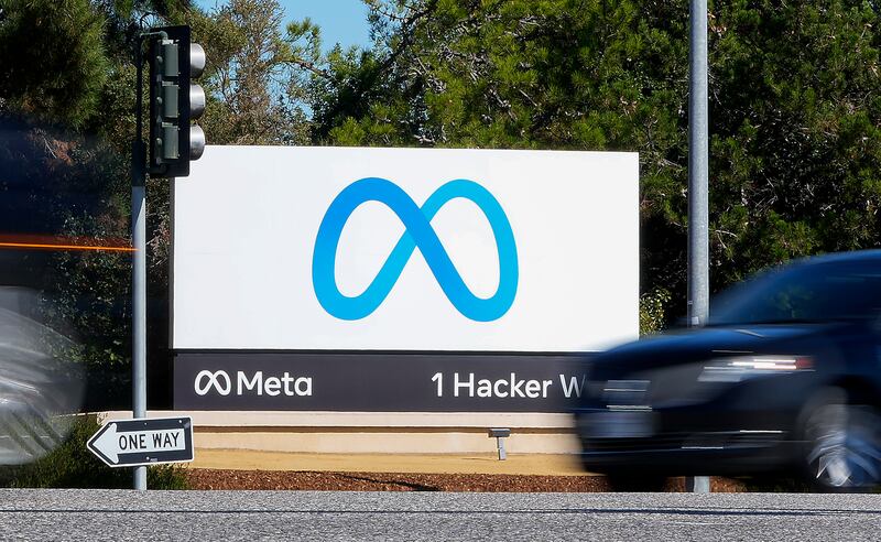 A car passes Facebook’s new Meta logo on a sign at the company headquarters on Oct. 28, 2021, in Menlo Park, Calif.