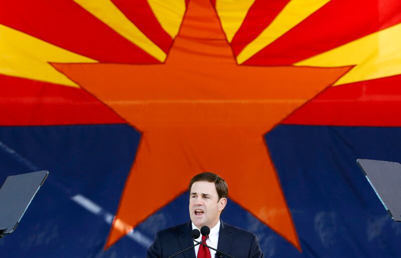 Arizona Gov. Doug Ducey addresses a crowd after being sworn into office in 2015.
