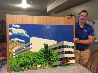 Dave Jungheim poses with his newly finished mosaic of the BYU Tanner Building.