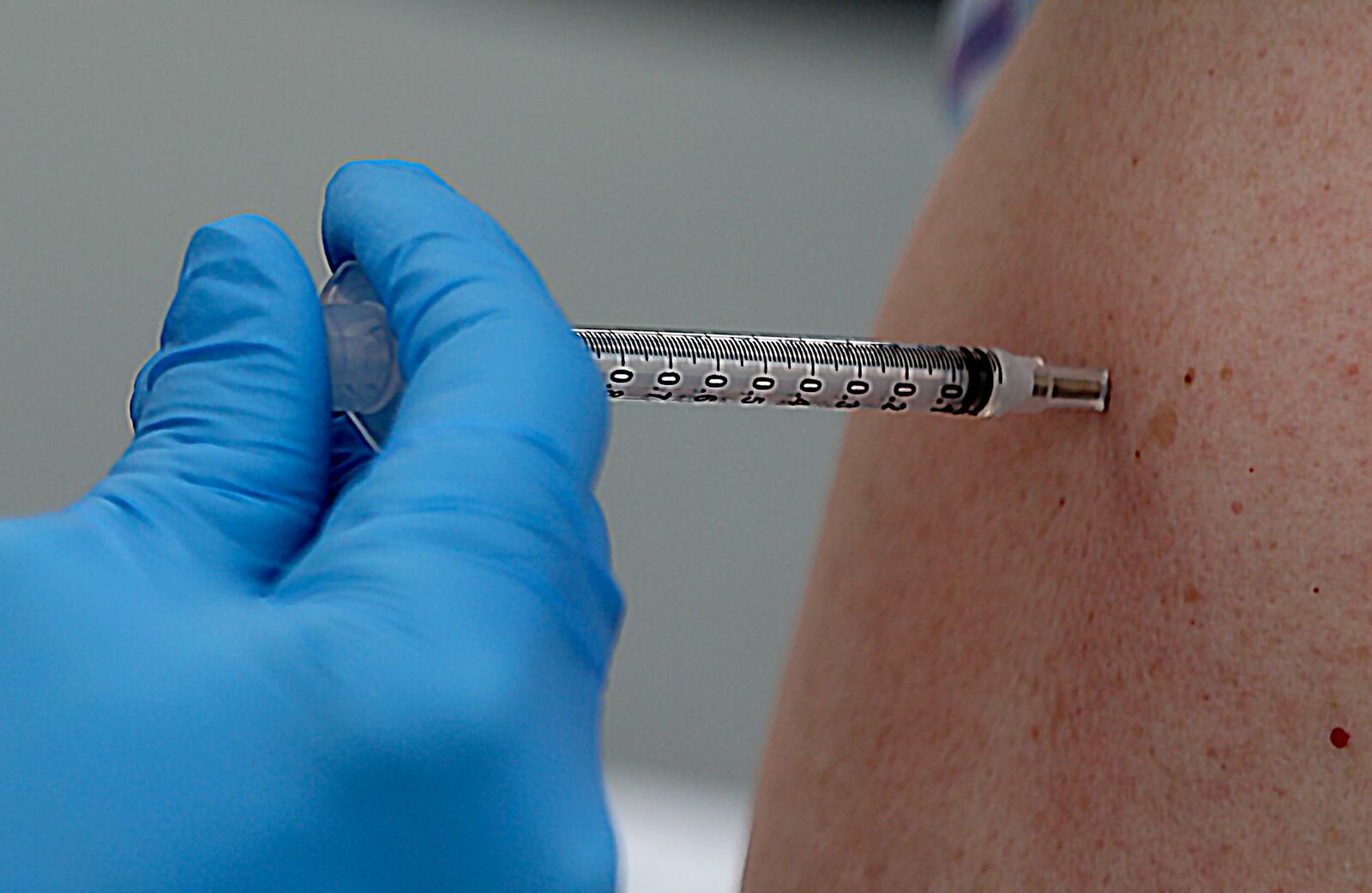 A COVID-19 vaccination is administered at a Salt Lake County Health Department.