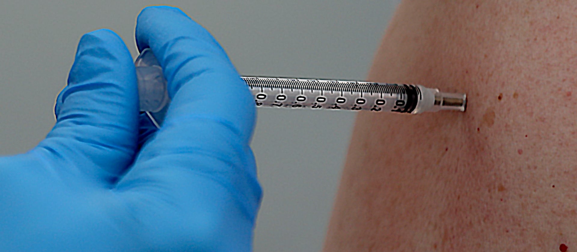 A COVID-19 vaccination is administered at a Salt Lake County Health Department.