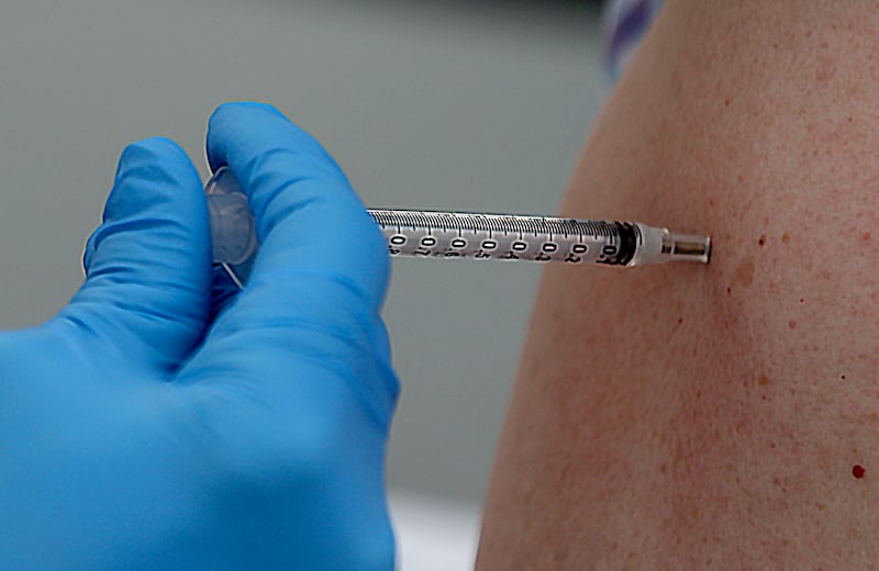 A COVID-19 vaccination is administered at a Salt Lake County Health Department.