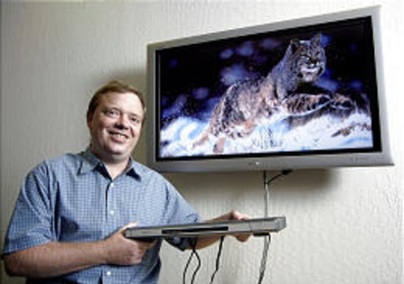 Anthony Wood shows off his company's new product, a high-definition media player.