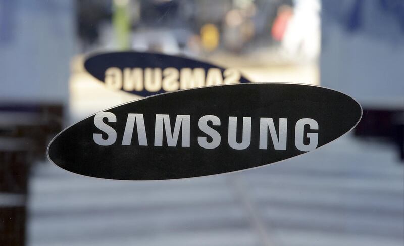 A logo of Samsung Electronics is seen at its showroom in Seoul, South Korea, Thursday, Jan. 8, 2015. Samsung Electronics Co. said Thursday its annual profit fell for the first time in three years as its smartphone growth lost steam.