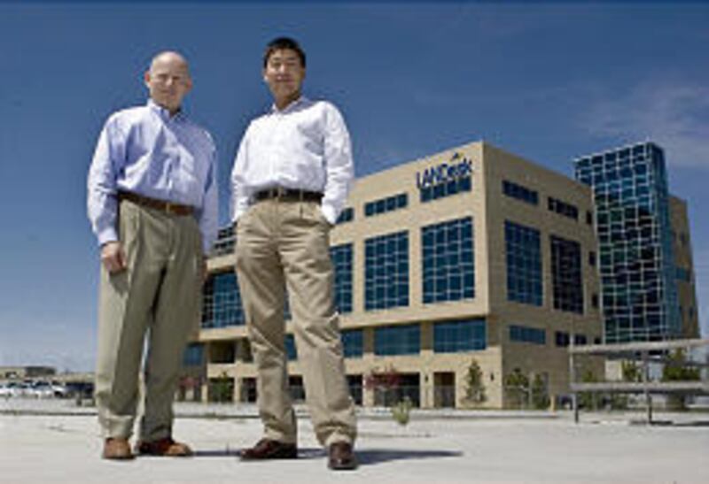 Joe Wang, CEO of LANDesk, stands with John Cooper, CEO of Avocent.