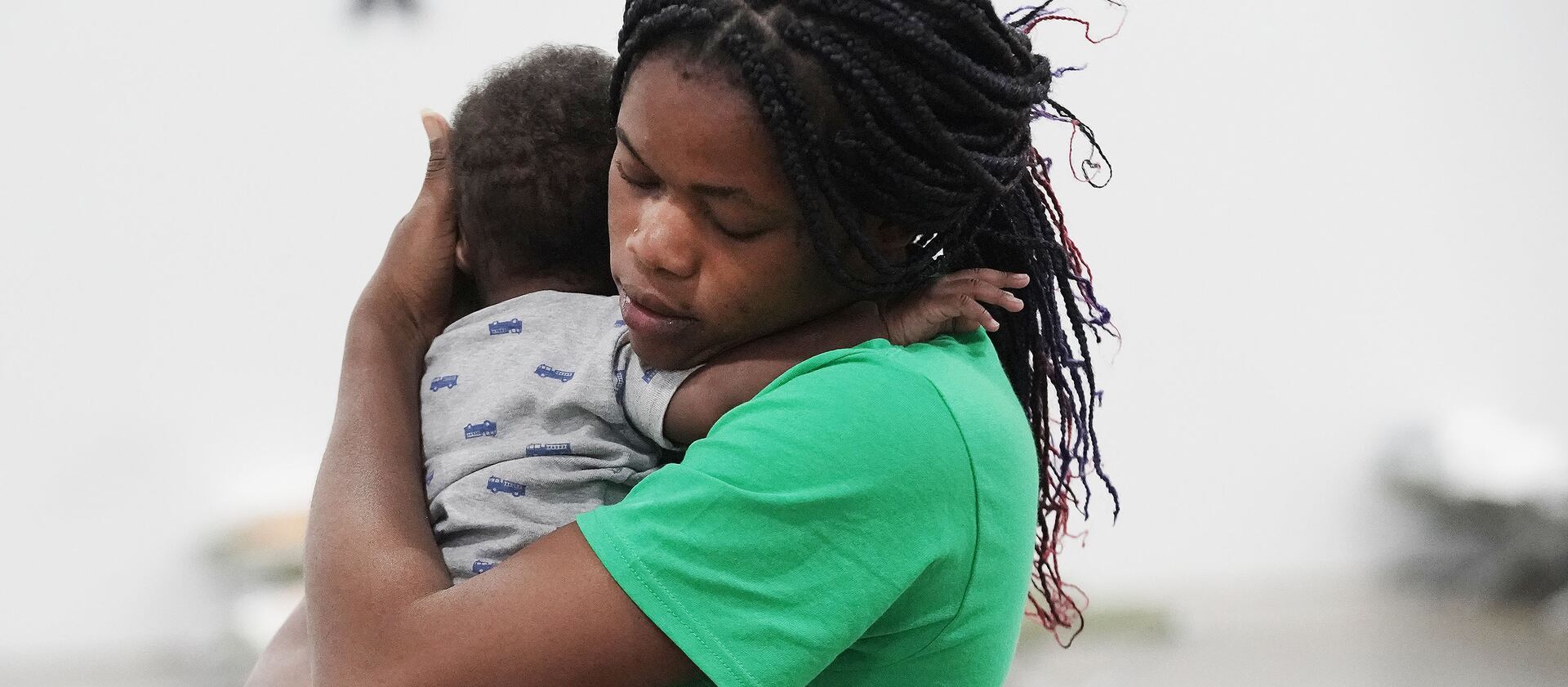 Haitian refugee Jouseline Melayer holds her baby, Jayden, at the Family Transfer Center in Houston.