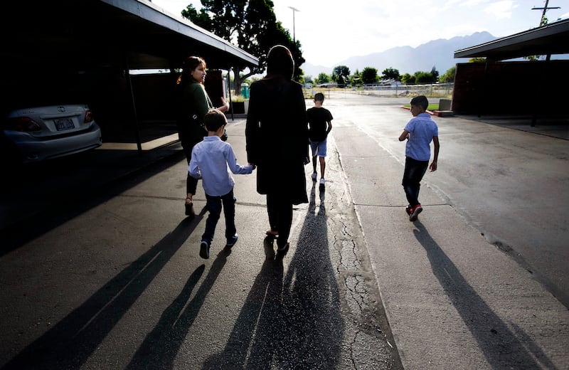 Baraa Huraideen, her sons, and interpreter Ghasaq Maiber walk to the Tumaini Welcome & Transition Center in South Salt Lake on Wednesday, Aug. 23, 2017. The boys spent two weeks at the center before heading to their new school.