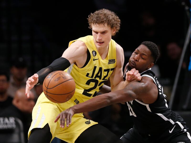 Utah Jazz forward Lauri Markkanen, left, and Brooklyn Nets forward Dorian Finney-Smith battle for the ball during the first half of an NBA basketball game Sunday, April 2, 2023, in New York. (AP Photo/John Munson)