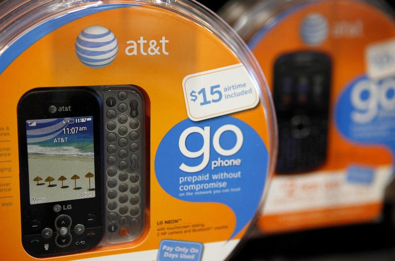 In this April 15, 2011 photo, AT&T Go phones are shown at a Best Buy store in San Francisco. AT&T subscribers are still buying iPhones, but with Verizon now selling the phone too, it seems to have lost its power to draw new subscribers to AT&T.