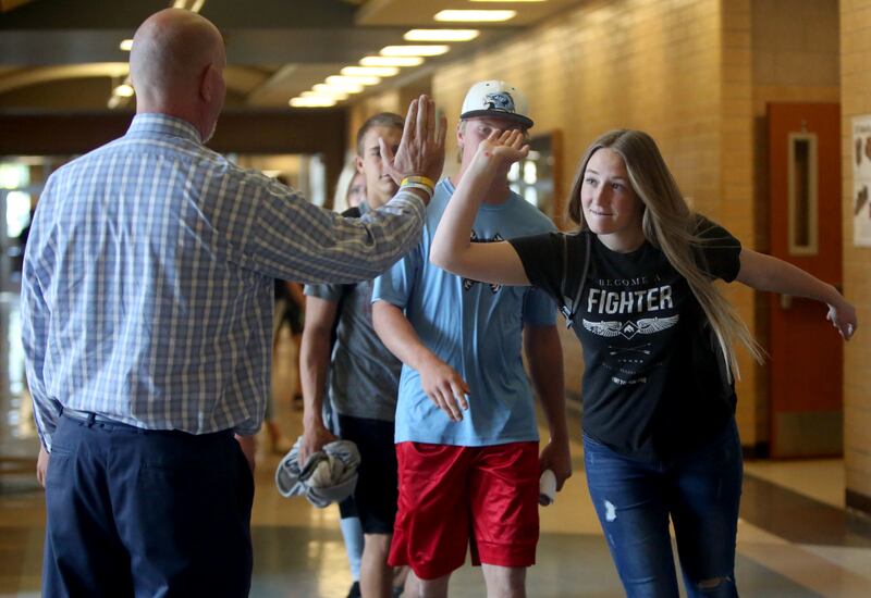 Principal Bart Peery high-fives Madison McNaughtan at Salem Hills High School in Salem on Thursday, May 24, 2018.