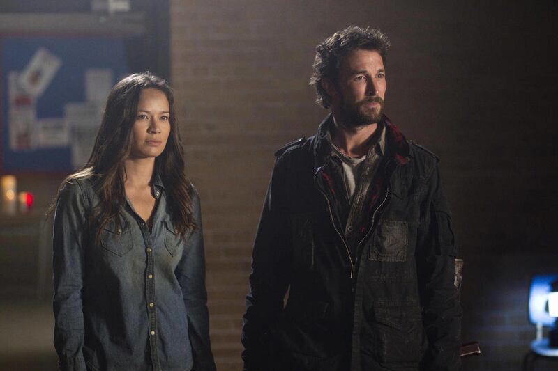 In this undated photo released by TNT, actors, Moon Bloodgood, left, and Noah Wyle, appear in a scene from TNT's "Falling Skies" Season Finale - Part 1: “Mutiny." Wyle is confronting an alien invasion, the death of his wife and the potential annihilation