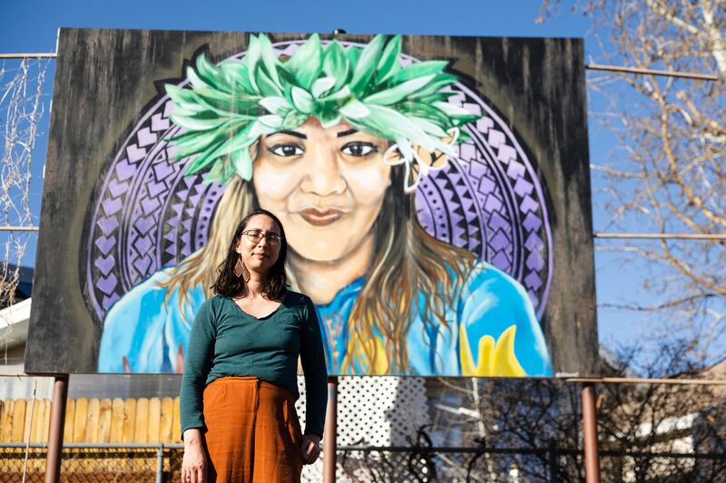Maile Arvin, a garden volunteer and University of Utah professor, poses for a portrait in front of a mural dedicated to Margarita Satini at the Og-Woi People's Garden in Salt Lake City on April 10.