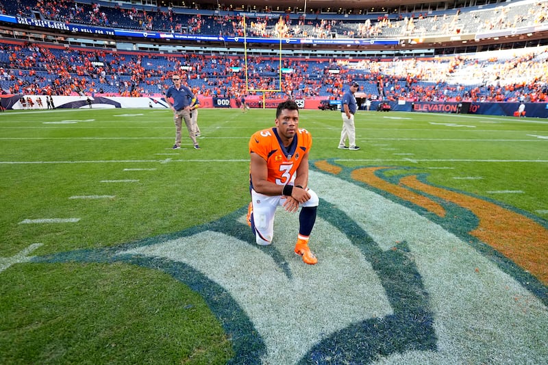 Denver Broncos quarterback Russell Wilson (3) kneels at mid field after playing the Houston Texans, Sunday, Sept. 18, 2022, in Denver.