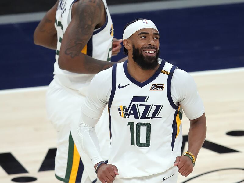 Utah Jazz guard Mike Conley smiles after dropping a 3-point shot as the Jazz and Sacramento play in Salt Lake City.