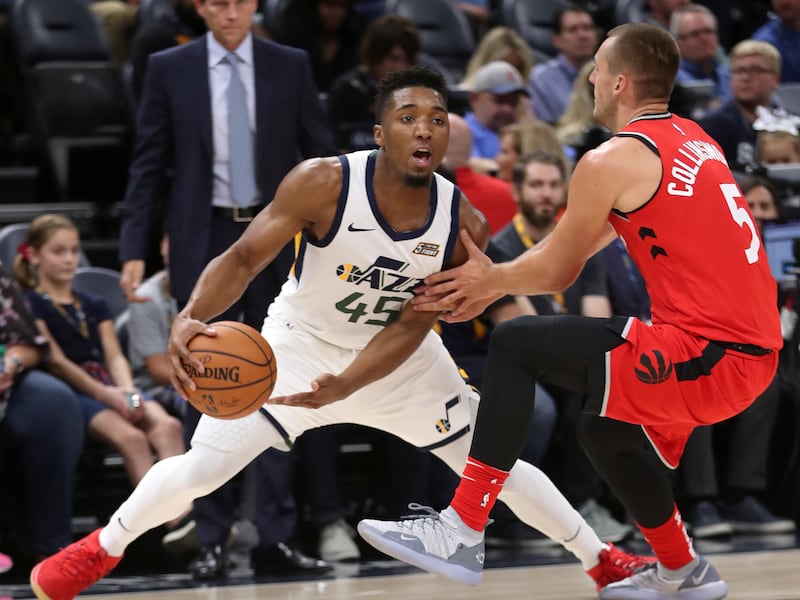 Toronto Raptors guard Kyle Collinsworth (5) tries to stay in front off Utah Jazz guard Donovan Mitchell (45) during the Toronto Raptors versus Utah Jazz preseason NBA basketball game at Vivint Arena in Salt Lake City on Tuesday, Oct. 2, 2018.