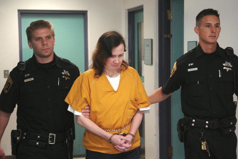 Sherrif's deputies escort Michele Kalina, 45, center, to her sentencing from central booking Thursday, Aug. 4, 2011 in Reading, Pa. Kalina was sentenced to 20 to 40 years in prison after pleading guilty to murder in connection with the deaths of five newb