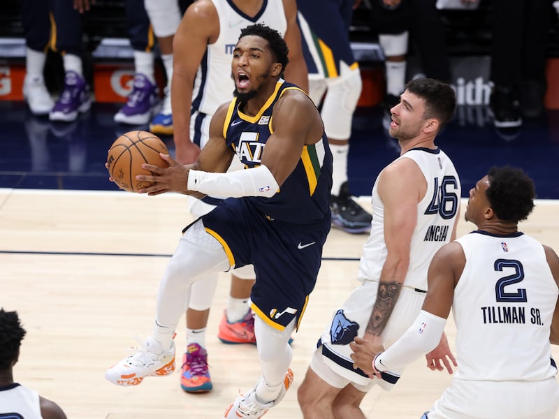 Utah Jazz guard Donovan Mitchell (45) jumps toward the basket as he gets past Memphis Grizzlies guard John Konchar (46) as the Utah Jazz and the Memphis Grizzlies play an NBA basketball game at Vivint Arena in Salt Lake City on Tuesday, April 5, 2022. Utah won 121-115.