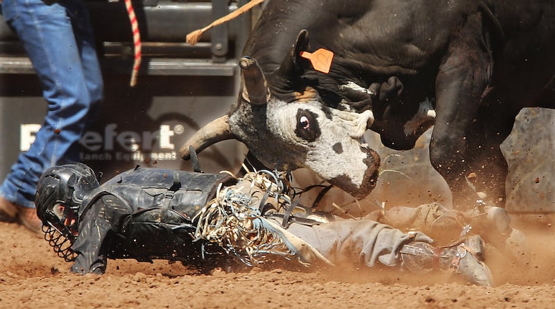 Briggs Madsen is thrown during bull riding during the Utah State High School Rodeo Finals in Heber on Wednesday, May 31, 2017.