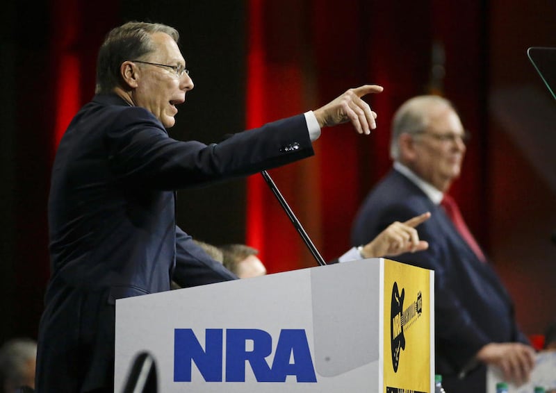 Wayne LaPierre, left, executive vice president of the National Rifle Association, speaks during the annual meeting of members at the NRA convention Saturday, April 11, 2015, in Nashville, Tenn.