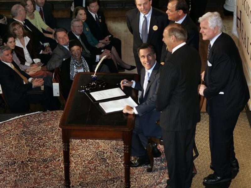 FILE - In this April 12, 2006, file photo Massachusetts Gov. Mitt Romney, reacts at Faneuil Hall in Boston after signing into law his landmark health care bill, designed to guarantee health insurance to virtually all Massachusetts residents. (AP Photo/Eli
