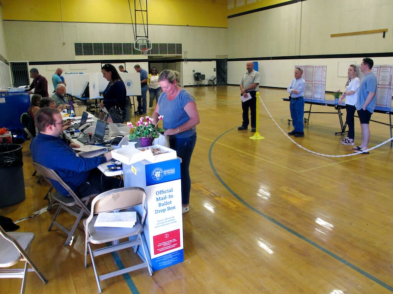 Washoe County voters line up inside a gymnasium .